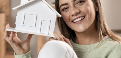 medium-shot-woman-holding-small-house
