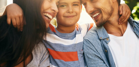 Hug, boy or portrait in park with family, smile and trust in nature on fun weekend break together. Parents, father or mother outside with love, care or happy kid on outdoor holiday vacation in Spain.